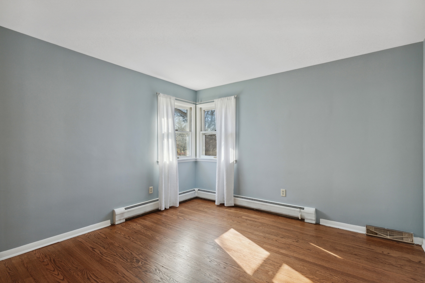 26075 Riverview Drive Antioch, IL 60002 - Photo 22 of 41 an empty room with wooden floor and windows