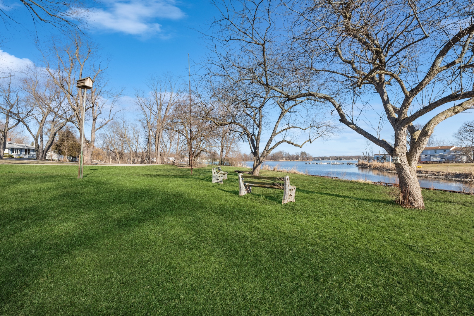 26075 Riverview Drive Antioch, IL 60002 - Photo 24 of 41 a white bench sitting in the grass near a tree