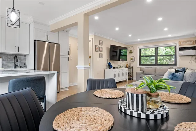 a living room with furniture a rug and kitchen view