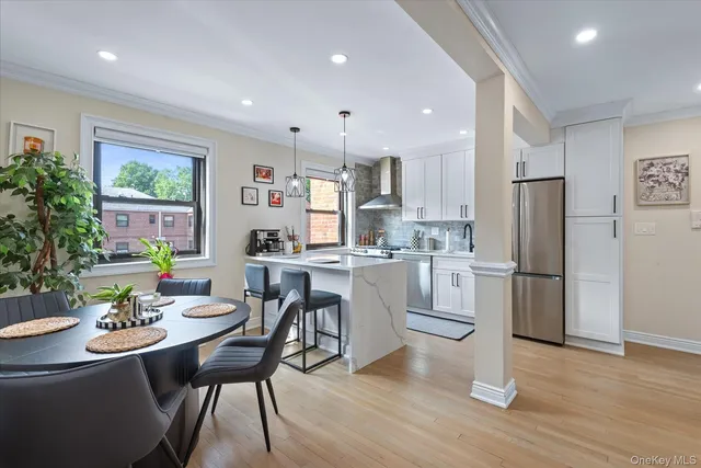 a kitchen with white cabinets and stainless steel appliances