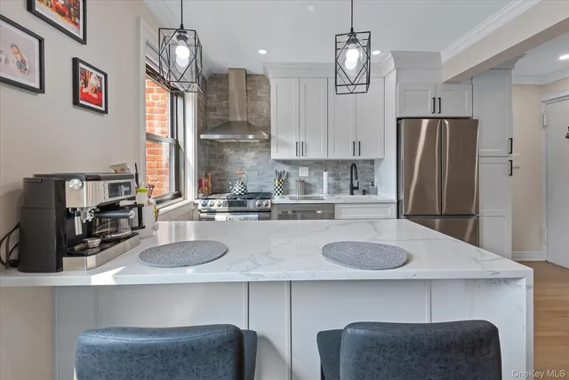 a kitchen with granite countertop a refrigerator a stove a sink and cabinets