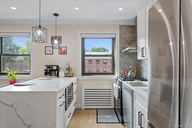 a kitchen with stainless steel appliances a refrigerator and a stove