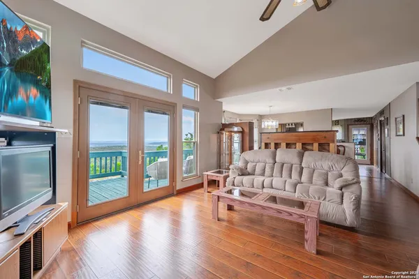 a living room with furniture and a wooden floor