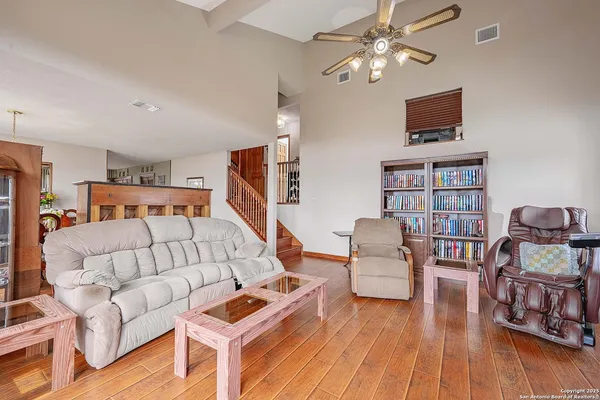 a living room with furniture and a wooden floor