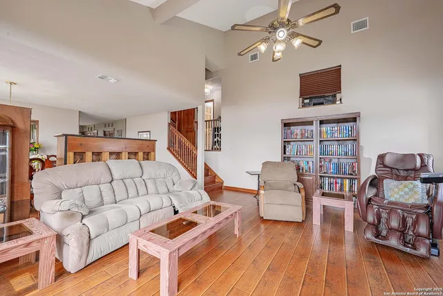 a living room with furniture and a wooden floor