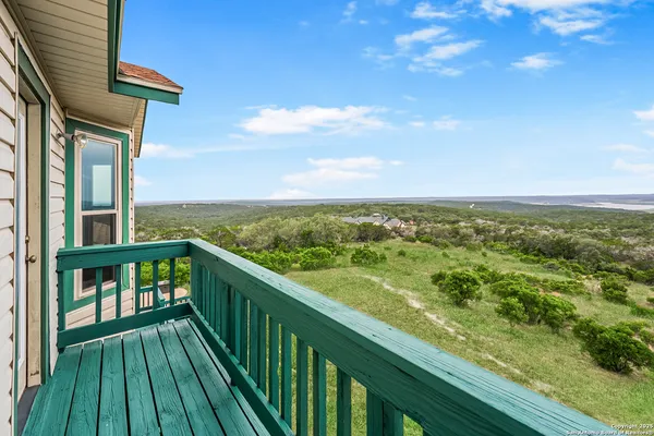 a view of balcony with yard