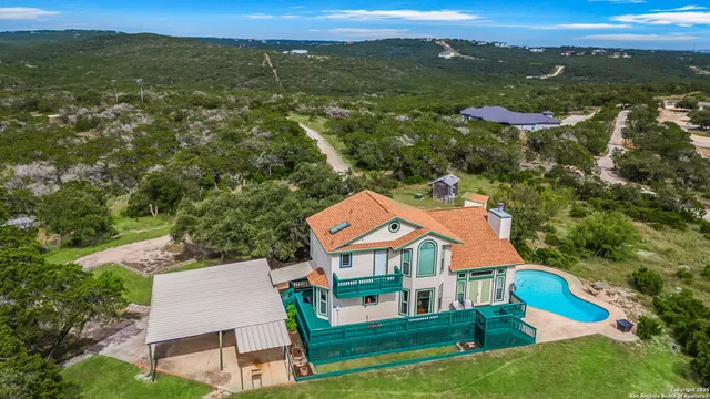 an aerial view of residential houses with outdoor space and ocean view