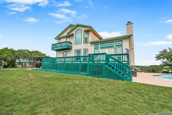 a view of an empty room with a window and a ceiling fan