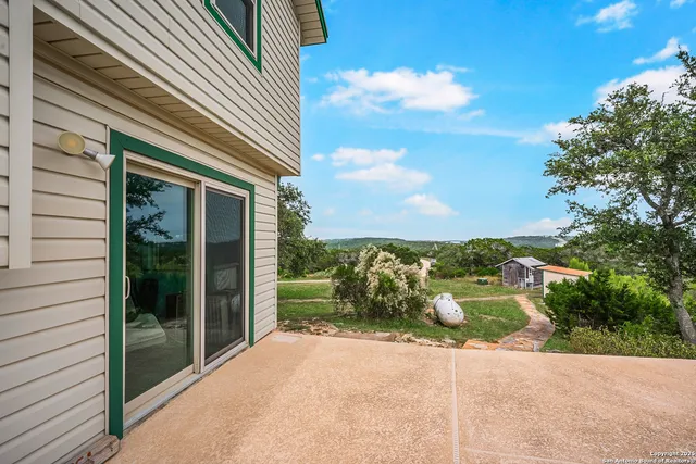 a view of a field of grass and trees