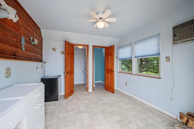 an aerial view of residential houses with outdoor space and trees