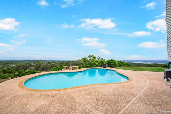 a view of a backyard with large trees