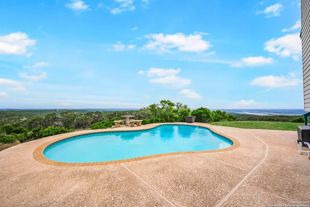 a view of a backyard with large trees