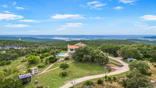 a view of a park with iron fence