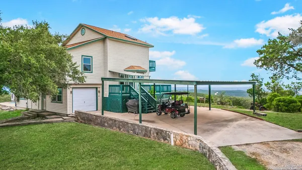 a view of a chair and table in backyard of the house