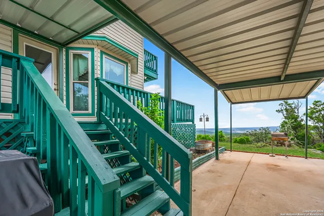 a kitchen with granite countertop a refrigerator and a dining table