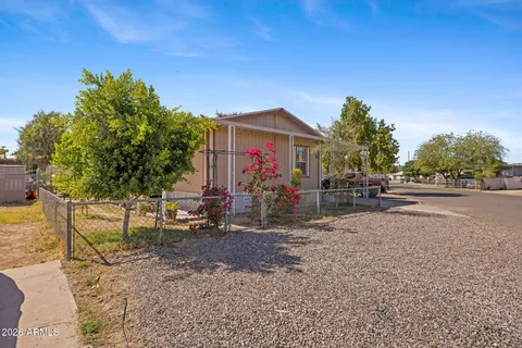 a view of a house with a yard and potted plants