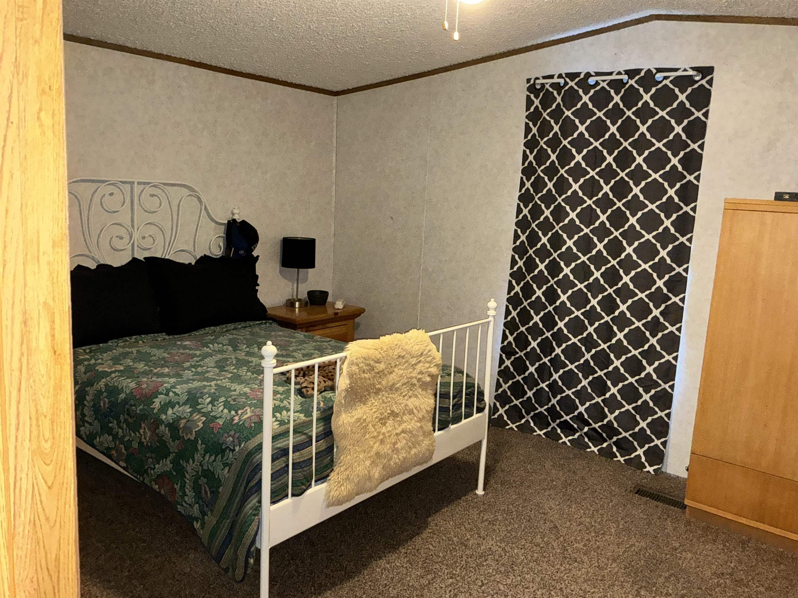 3268 E Road, Unit 90 Clifton, CO 81520 - Photo 12 of 19 a bedroom with a bed and a walk in closet