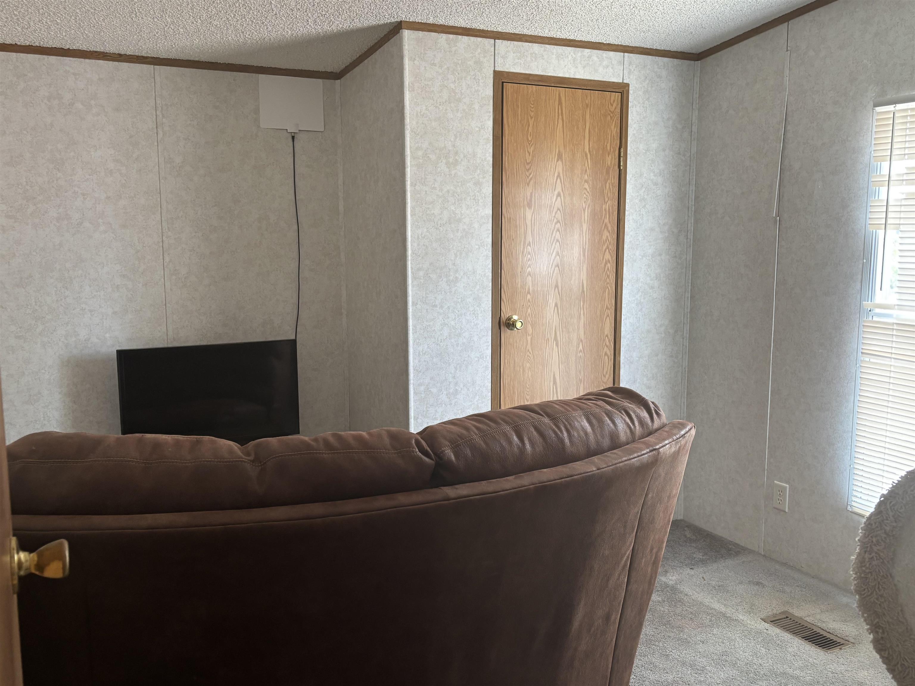 3268 E Road, Unit 90 Clifton, CO 81520 - Photo 18 of 19 a living room with furniture and a window