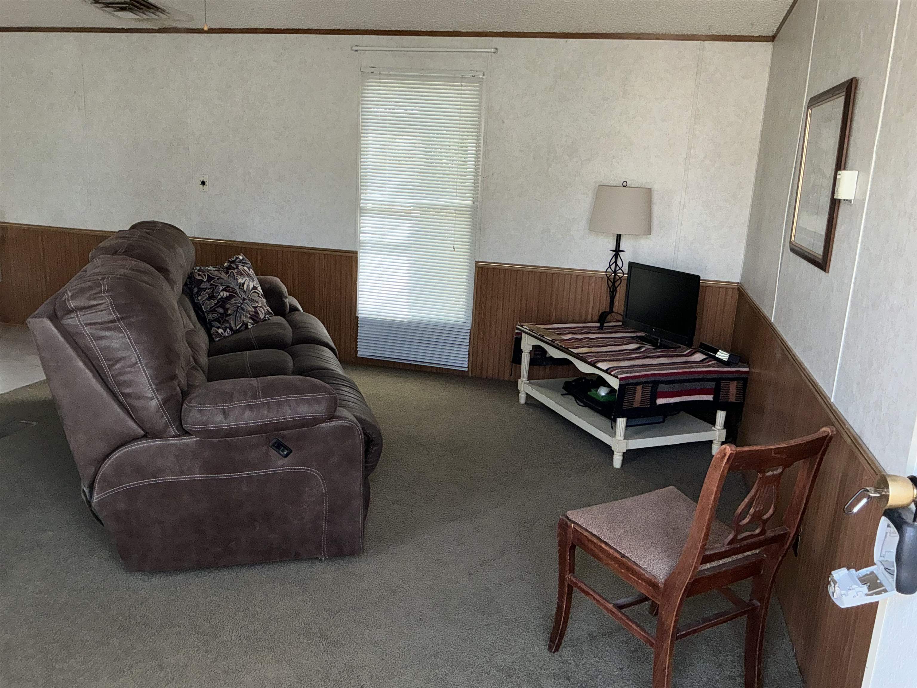 3268 E Road, Unit 90 Clifton, CO 81520 - Photo 6 of 19 a living room with furniture and a lamp