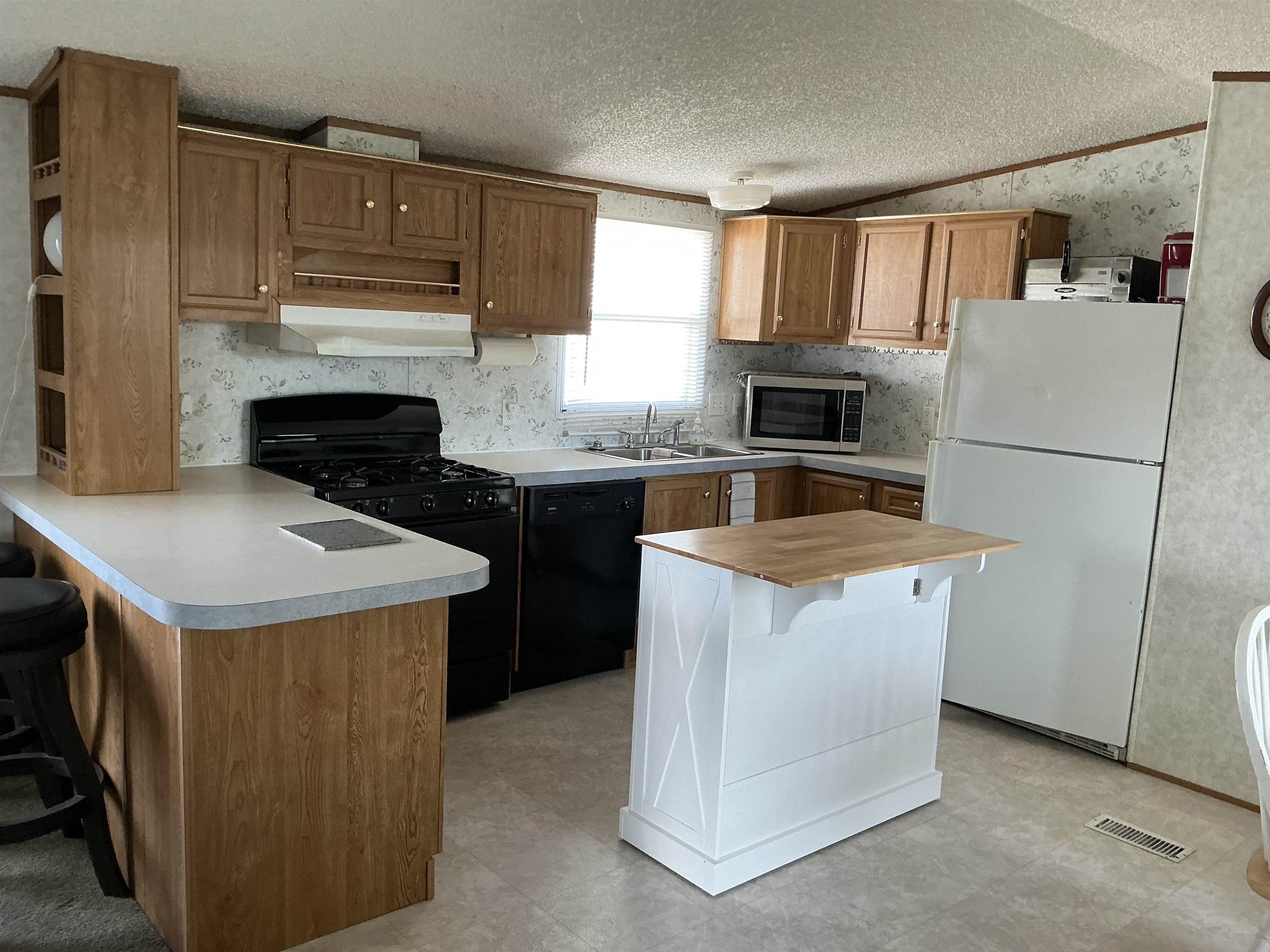 3268 E Road, Unit 90 Clifton, CO 81520 - Photo 10 of 19 a kitchen with a stove a refrigerator and a sink