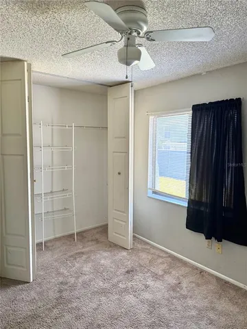 an empty room with windows and closet