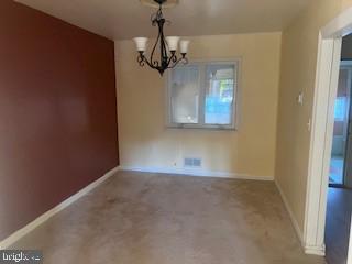 2746 Moorgate Road Baltimore, MD 21222 - Photo 4 of 14 a view of a room with a chandelier fan and a window