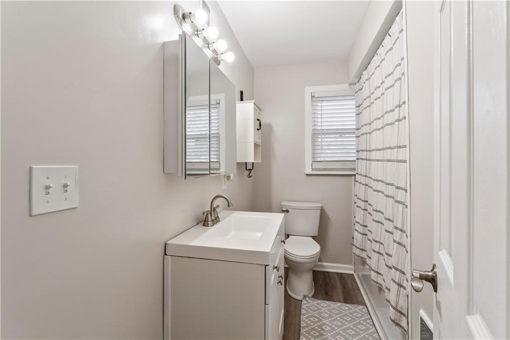 951 Shenango Road Beaver Falls, PA 15010 - Photo 19 of 42 a bathroom with a sink a toilet and shower curtain