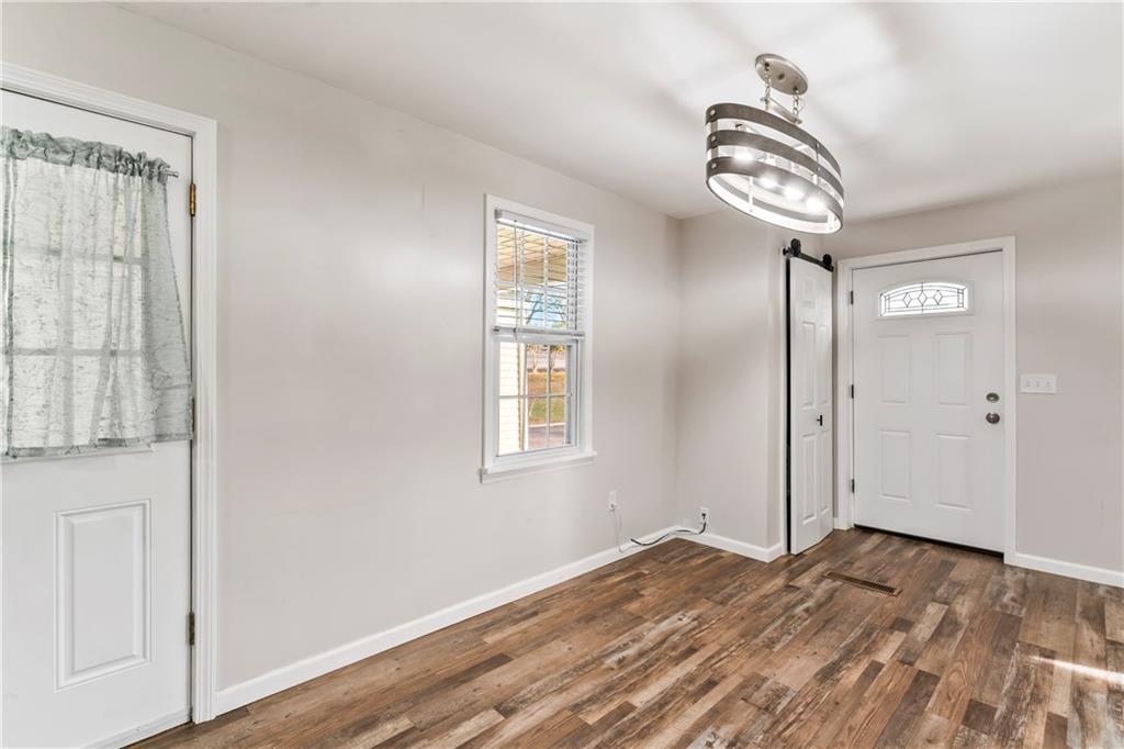 951 Shenango Road Beaver Falls, PA 15010 - Photo 3 of 42 a view of empty room with wooden floor and fan