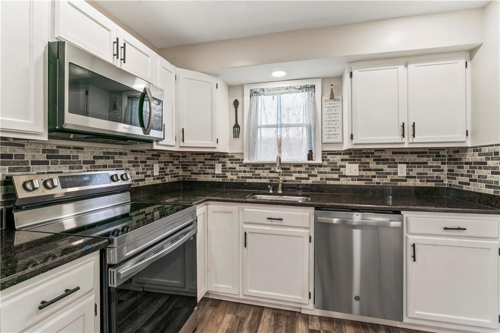 951 Shenango Road Beaver Falls, PA 15010 - Photo 7 of 42 a kitchen with stainless steel appliances granite countertop a stove a sink and a microwave