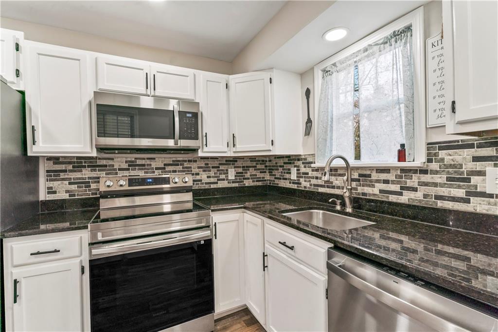 951 Shenango Road Beaver Falls, PA 15010 - Photo 8 of 42 a kitchen with granite countertop a sink stainless steel appliances and cabinets