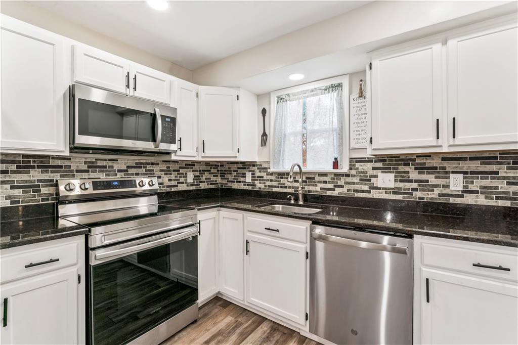 951 Shenango Road Beaver Falls, PA 15010 - Photo 9 of 42 a kitchen with stainless steel appliances a stove sink microwave and cabinets