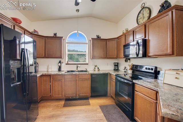 35 Cree Path Lake George, CO 80827 - Photo 13 of 46 Kitchen with light hardwood / wood-style floors, hanging light fixtures, lofted ceiling, black appliances, and ceiling fan