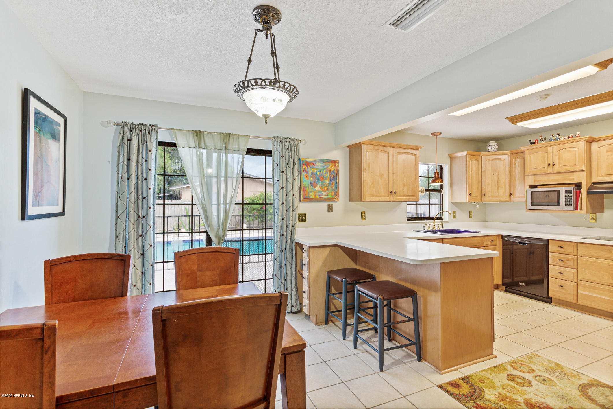 325 Orchis Road St. Augustine, FL 32086 - Photo 9 of 46 a open kitchen with stainless steel appliances granite countertop a table and chairs in it