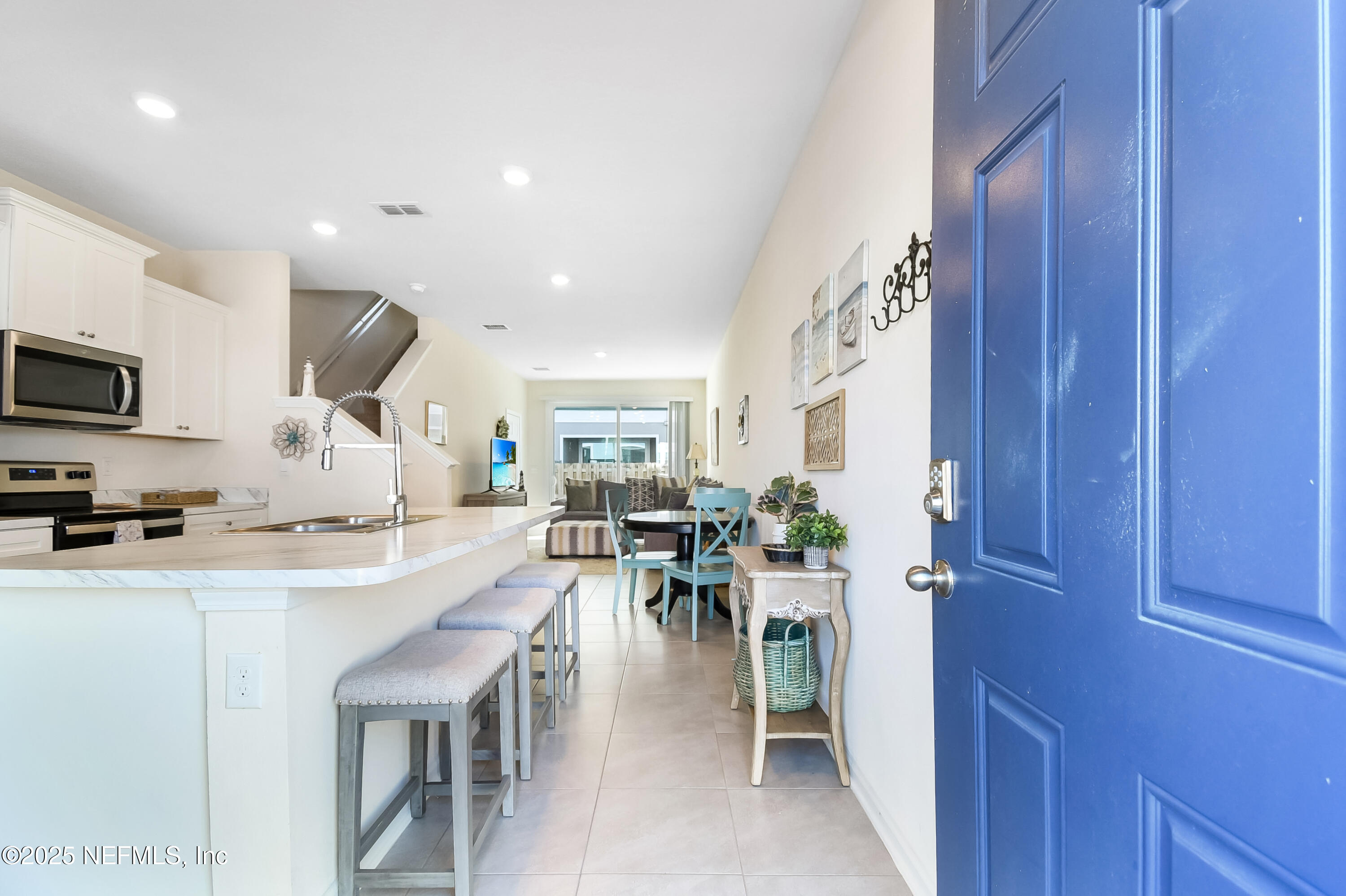 94 Red House Cir Street St. Augustine, FL 32084 - Photo 1 of 28 a dining hall with stainless steel appliances granite countertop a stove a sink a oven with a dining table and chairs