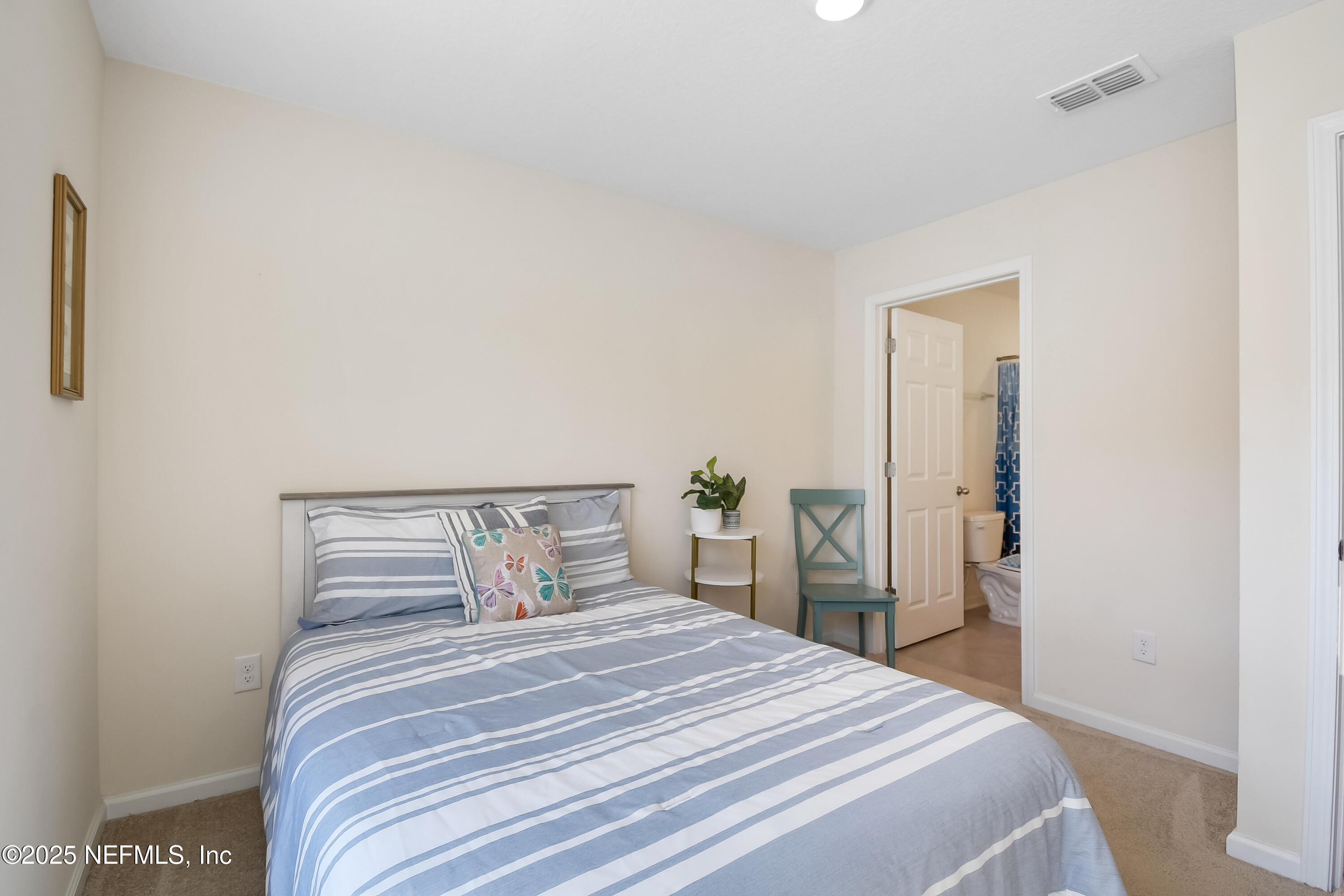 94 Red House Cir Street St. Augustine, FL 32084 - Photo 14 of 28 a bedroom with a bed and a mirror