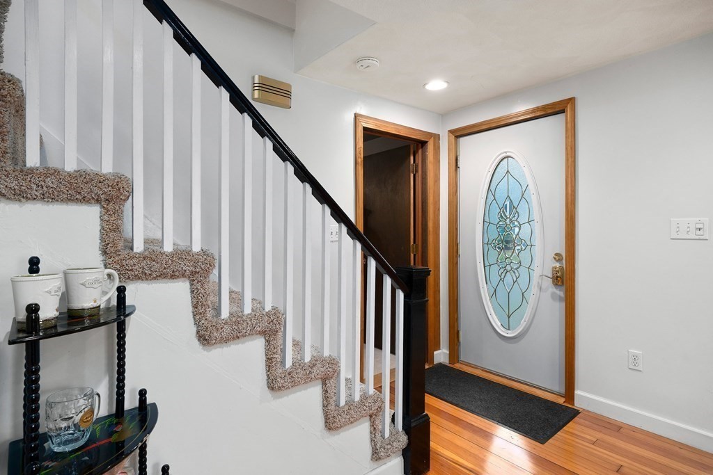 102 Orange Street Reading, MA 01867 - Photo 3 of 23 a view of a hallway with wooden floor and entryway