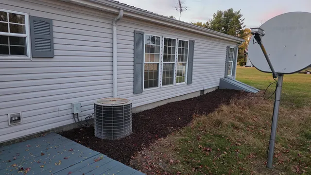 a view of a house with backyard and sitting area
