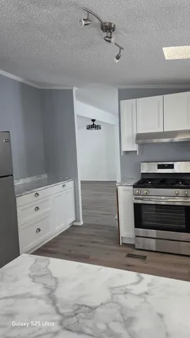 a view of kitchen and wooden floor