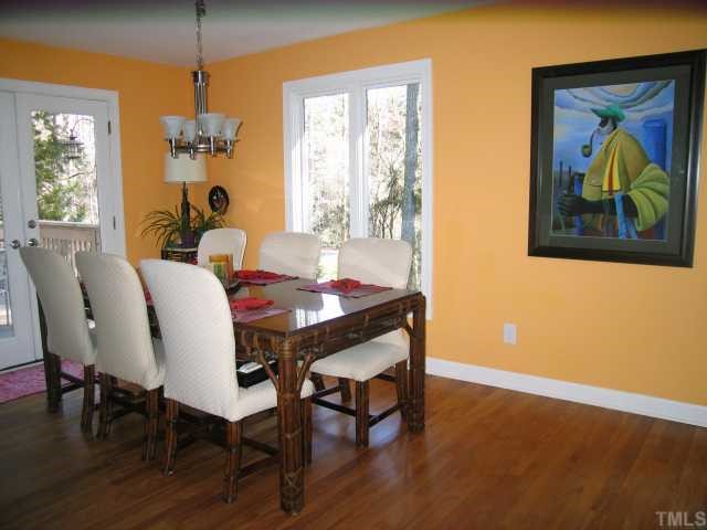 8804 Boar's Head Court Raleigh, NC 27613 - Photo 5 of 12 a view of a dining room with furniture window and wooden floor