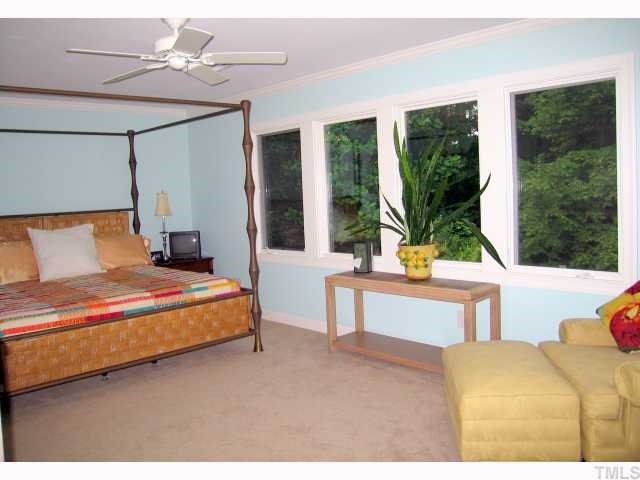 8804 Boar's Head Court Raleigh, NC 27613 - Photo 7 of 12 a bedroom with a bed and a large window