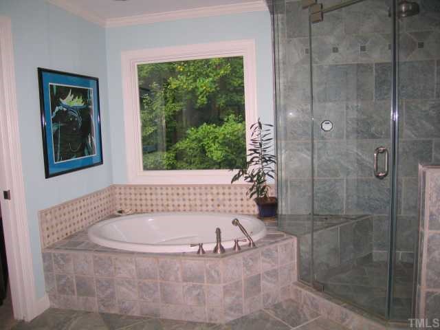8804 Boar's Head Court Raleigh, NC 27613 - Photo 9 of 12 a bath tub sitting next to a window