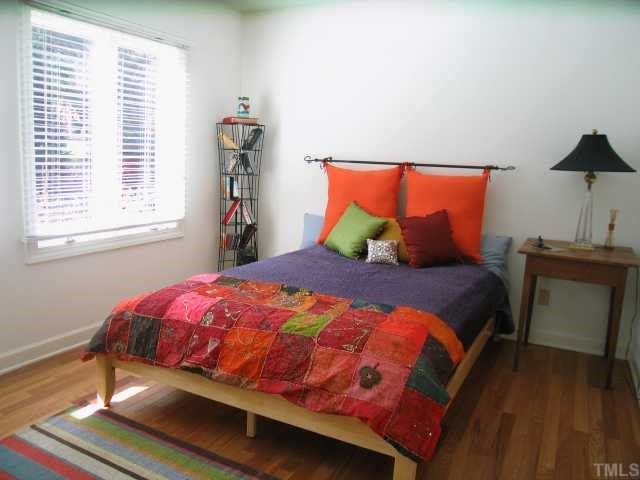 8804 Boar's Head Court Raleigh, NC 27613 - Photo 10 of 12 a bedroom with a bed and a window