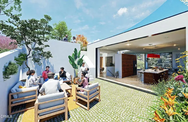 a dining room with furniture potted plants and wooden floor