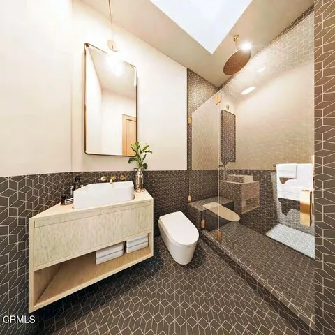 a bathroom with a sink mirror toilet and bathtub