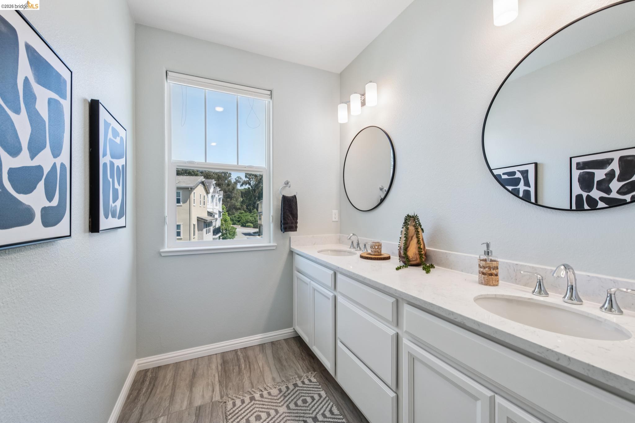 24157 Amaranth Loop Hayward, CA 94541 - Photo 39 of 63 Dual vanity with white cabinetry and integrated sinks set in a light-colored countertop