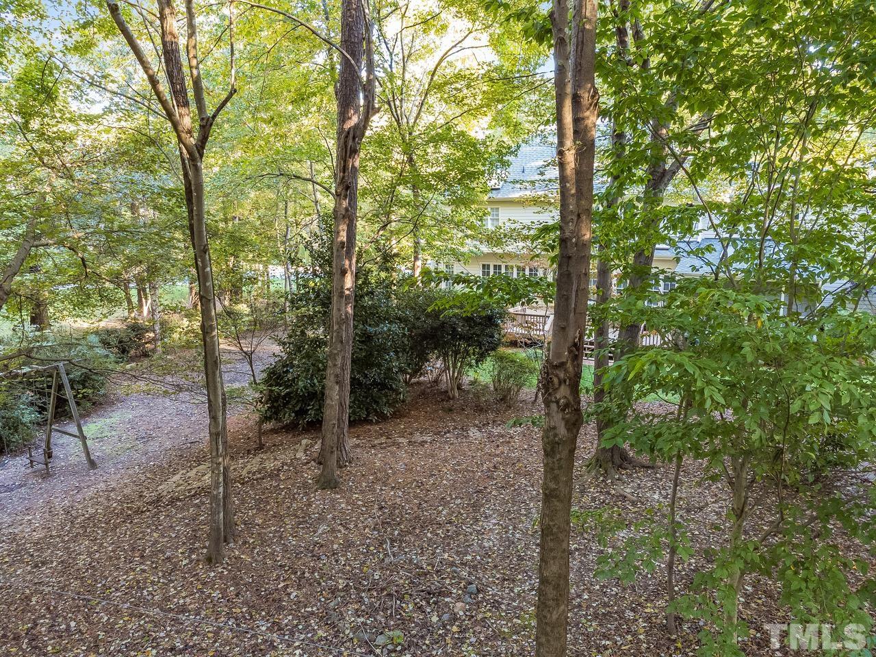Aerial view from back yard facing the home. The tree canopy prevents a good photo. You will enjoy the shade in the summer.