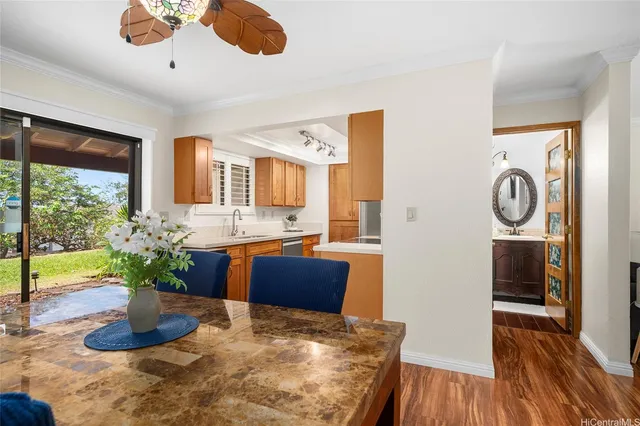 a kitchen with stainless steel appliances granite countertop a refrigerator a stove and a wooden floors