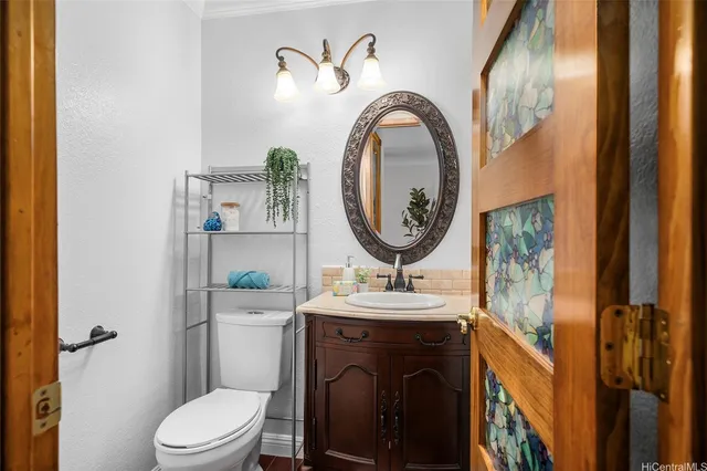 a bathroom with a toilet a sink and a mirror