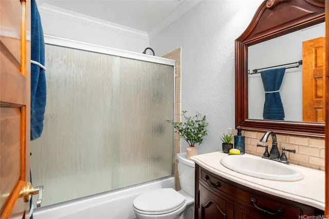 a bathroom with a sink a toilet a mirror and shower