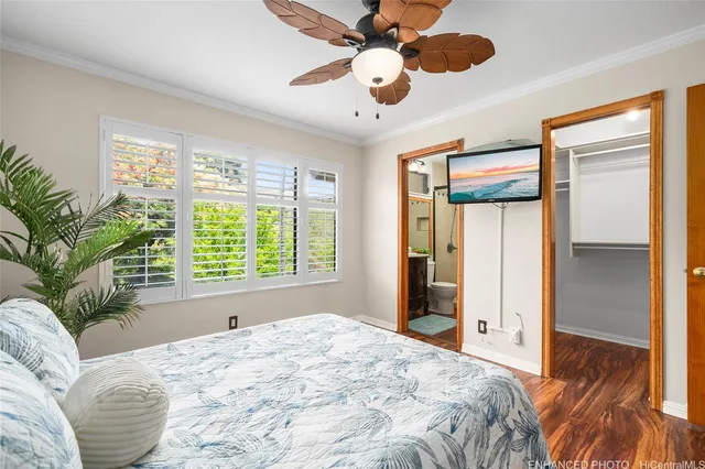 a bedroom with a large bed and a large window